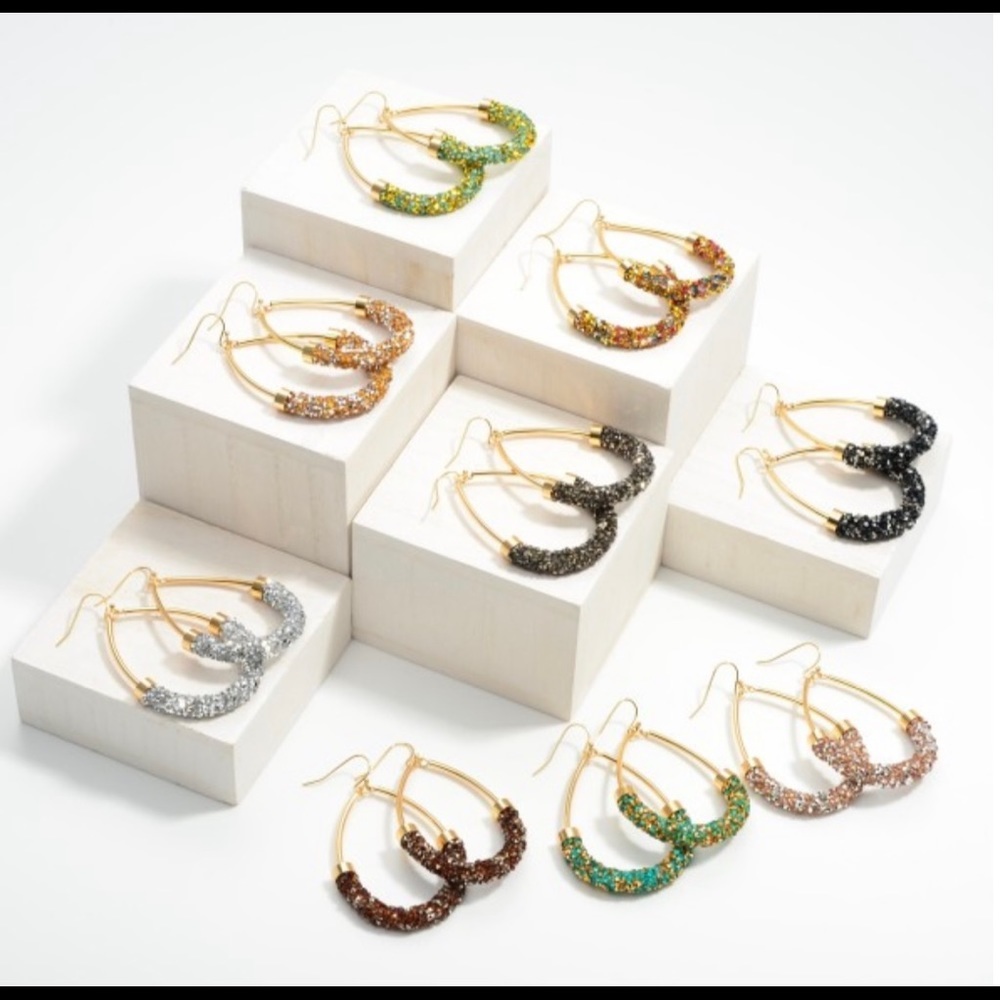 Rhinestone encrusted gold tone teardrop earrings.